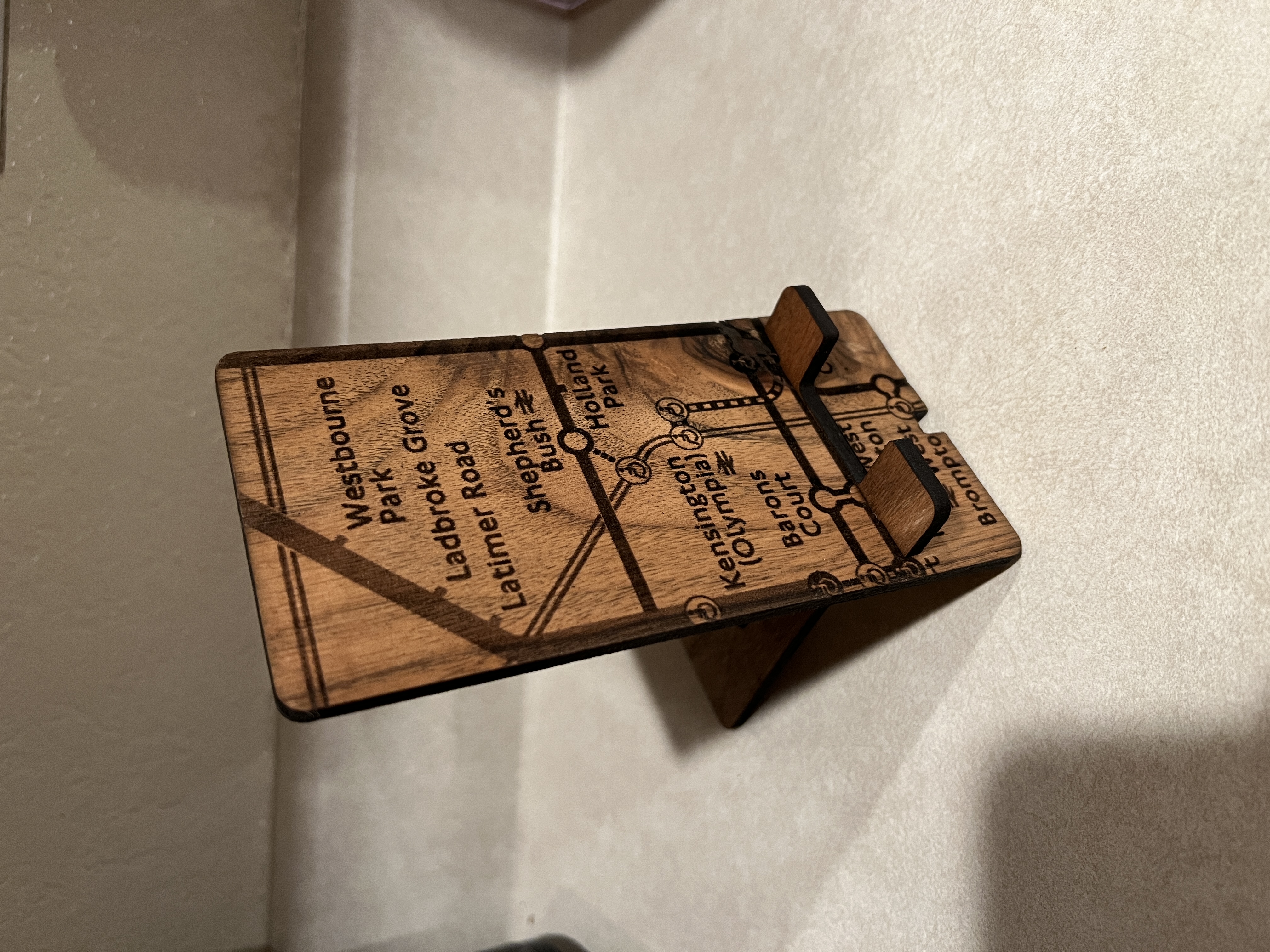 Custom Phone Stand: A wooden phone stand engraved with a custom map, in this case London, turning an everyday object into a personal keepsake.